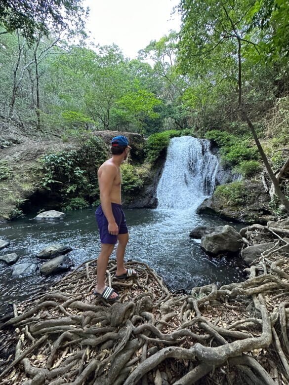 my brother in front of rio negro waterfall, guanacaste