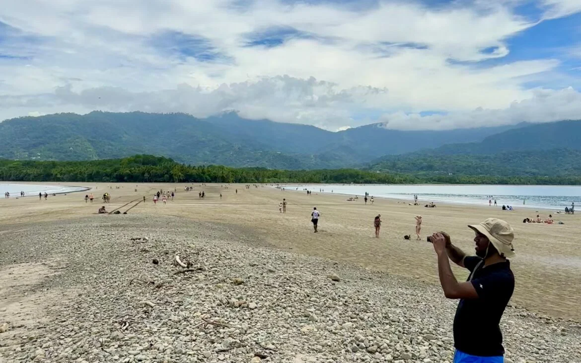 Uvita whale tail at low tide, Arujan taking photos on the rocks