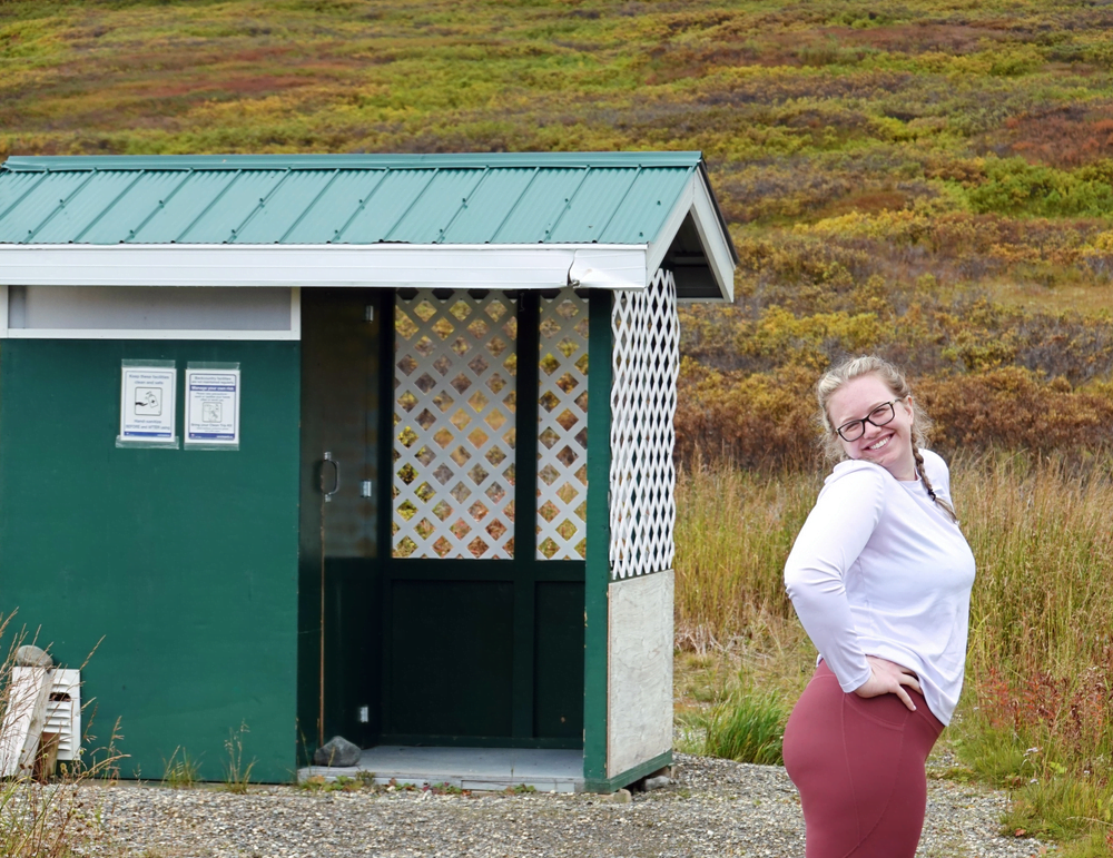 Posing at the outhouse of the Samuel Glacier hike trailhead