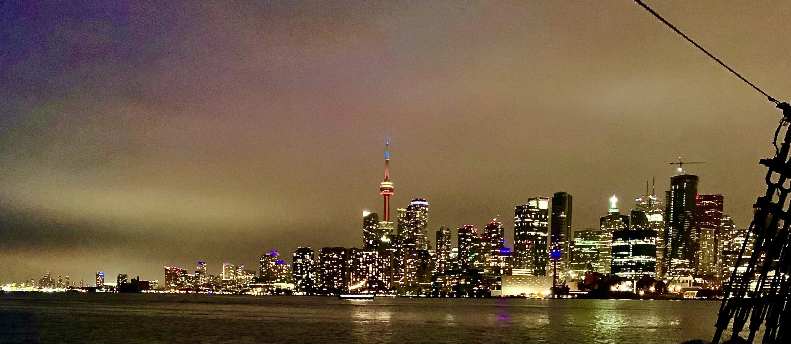 Toronto Skyline on a cloudy night in Toronto from Lake Ontario boat cruise