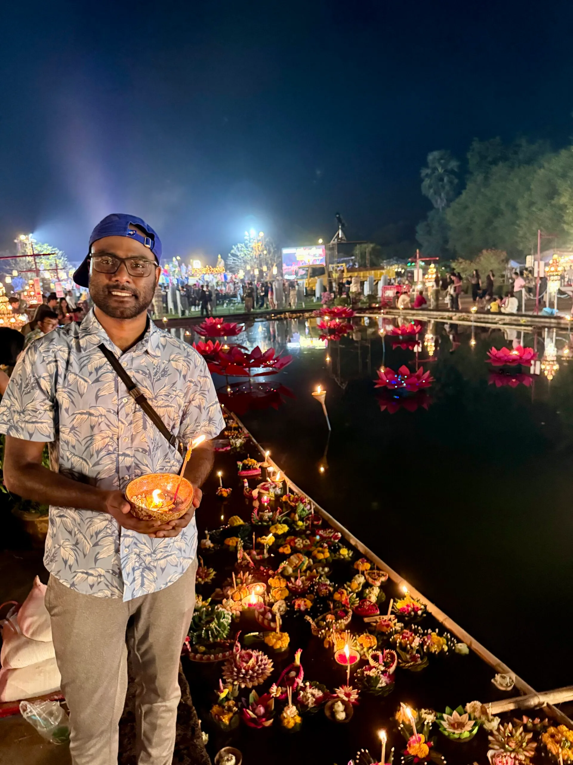 Arujan holding a krathong at Loy Krathong Festival in Sukhothai
